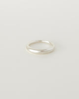 A simple silver dome-shaped ring with soft curved edges, displayed on a white background.