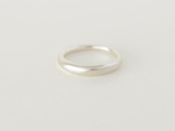 A simple silver dome-shaped ring with soft curved edges, displayed on a white background.