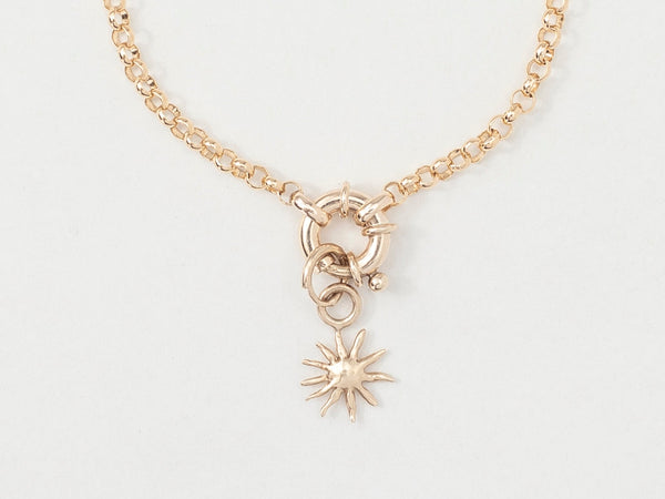 A gold bracelet featuring a golden sun charm centered on an 18cm bold belcher chain.